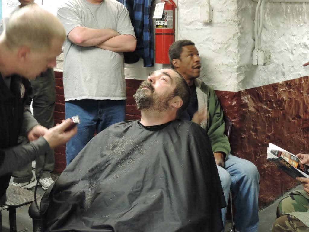 A community member receiving a free haircut at a Blessing by Barbers event